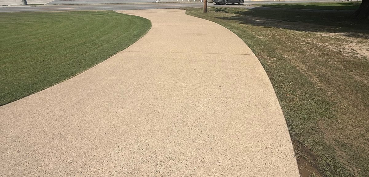 Freshly pressure washed concrete driveway