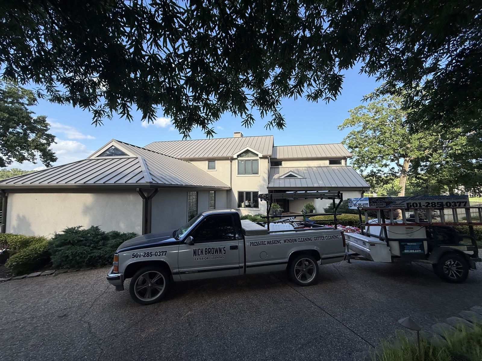 Nick Brown's Exterior Cleaning truck and trailer parked at a job site in Central Arkansas
